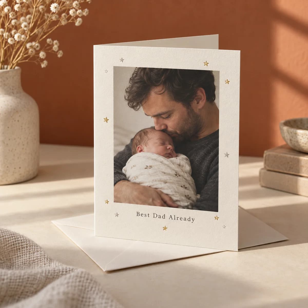 Greeting card with a photo of a father and his newborn